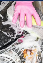 Hand washing a car with soap suds at One Stop Detail Shop